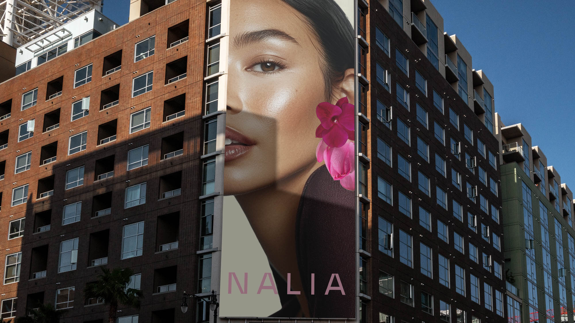 Nalia campaign visual with botanical textures and warm skin tones